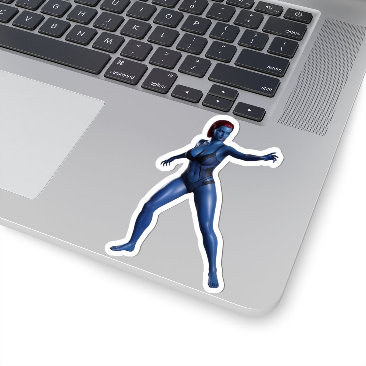 Mystique Sticker – Comic Character Vinyl Sticker for Laptops & Indoor Decor on silver laptop, glossy blue comic-style character vinyl sticker