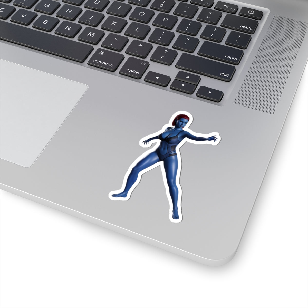 Mystique Sticker – Comic Character Vinyl Sticker for Laptops & Indoor Decor on silver laptop, glossy durable vinyl, bold comic-style blue character