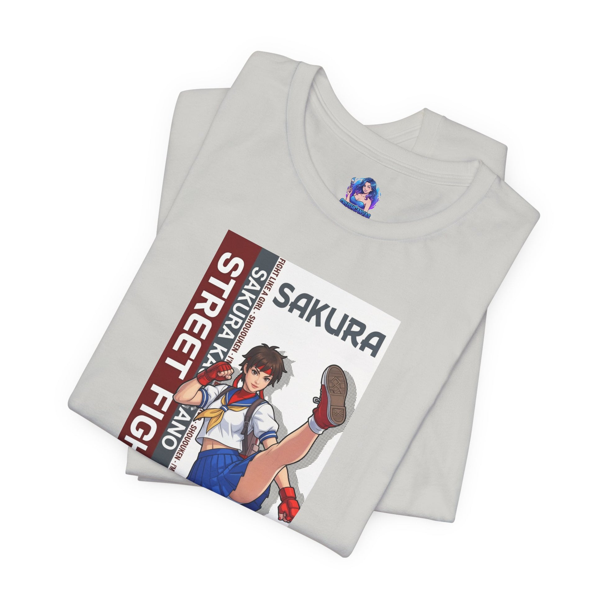 Sakura Kasugano T-Shirt | Street Fighter Anime Tee for Gamers & Fighting Game Fans - folded grey Bella Canvas tee with anime Sakura print