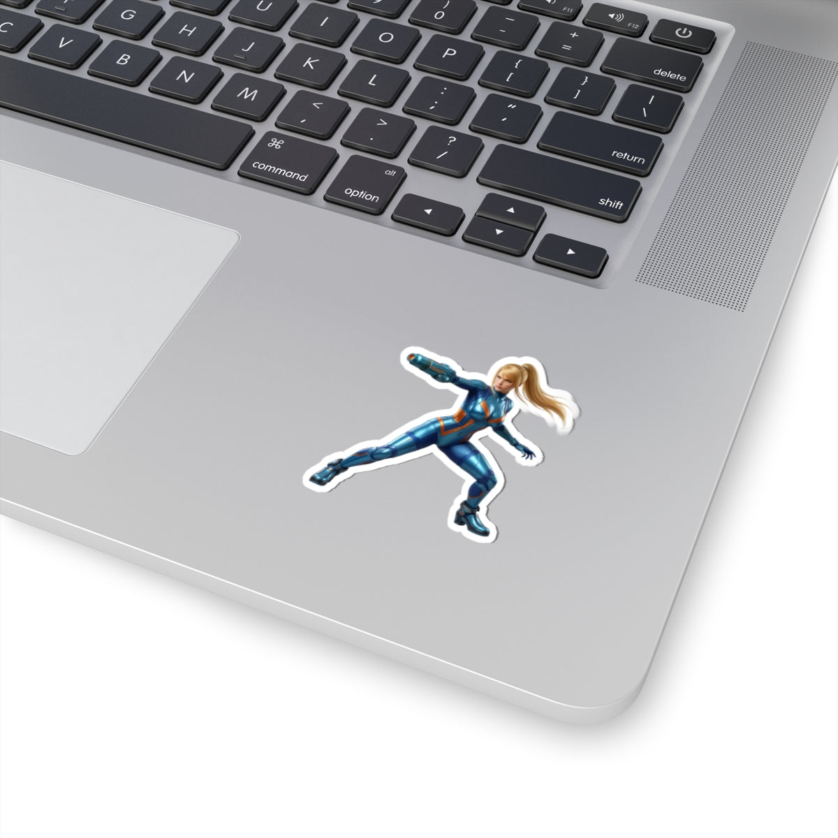 Samus Aran Sticker – Futuristic Game Vinyl Sticker for Laptops & Indoor Decor: glossy durable vinyl laptop sticker showing Samus Aran in blue suit on silver laptop