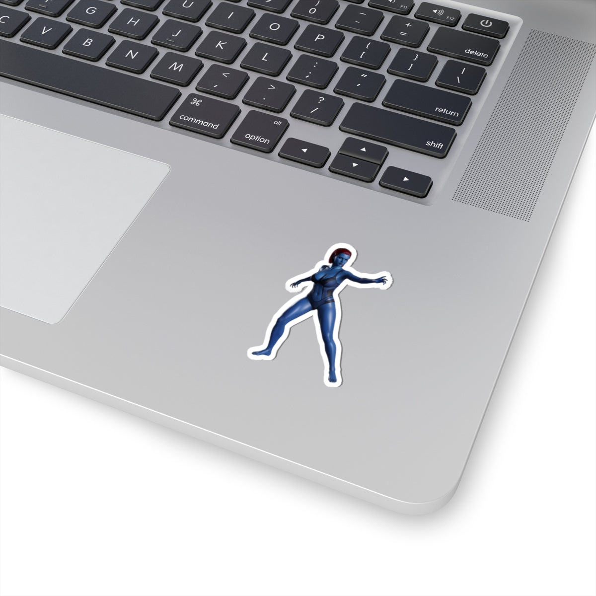 Mystique Sticker – Comic Character Vinyl Sticker for Laptops & Indoor Decor on silver laptop showing glossy, durable vinyl sticker with vibrant colors and bubble-free finish
