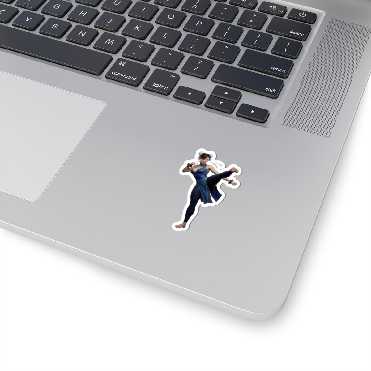 Chun-Li Sticker – Street Fighter Vinyl Sticker for Laptops & Indoor Decor on silver laptop corner showing glossy vinyl decal of iconic fighting-game character in action pose