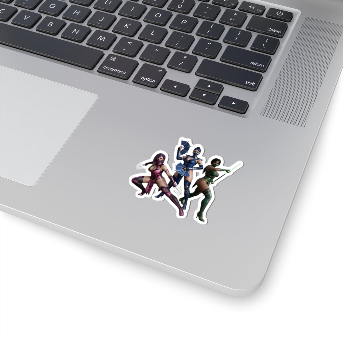 Kitana, Jade, Mileena Sticker – Mortal Kombat Vinyl Sticker for Laptops & Indoor Decor on silver laptop showing three characters sticker