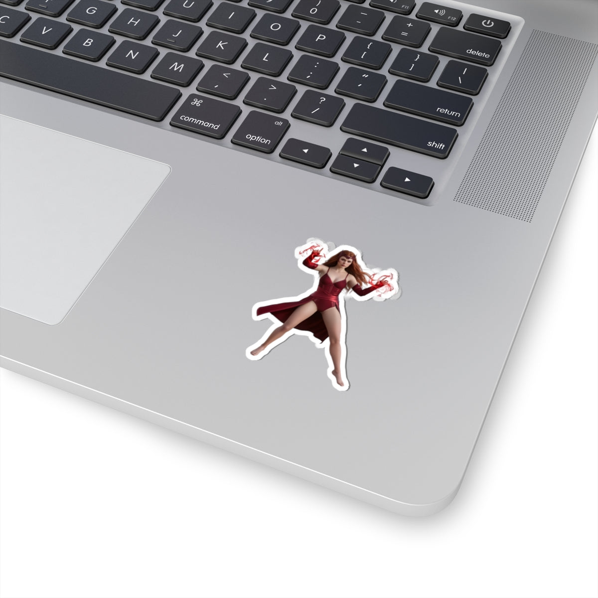 Scarlet Witch Sticker – Comic Heroine Vinyl Sticker for Laptops & Indoor Decor shown on silver laptop corner with glossy vibrant print