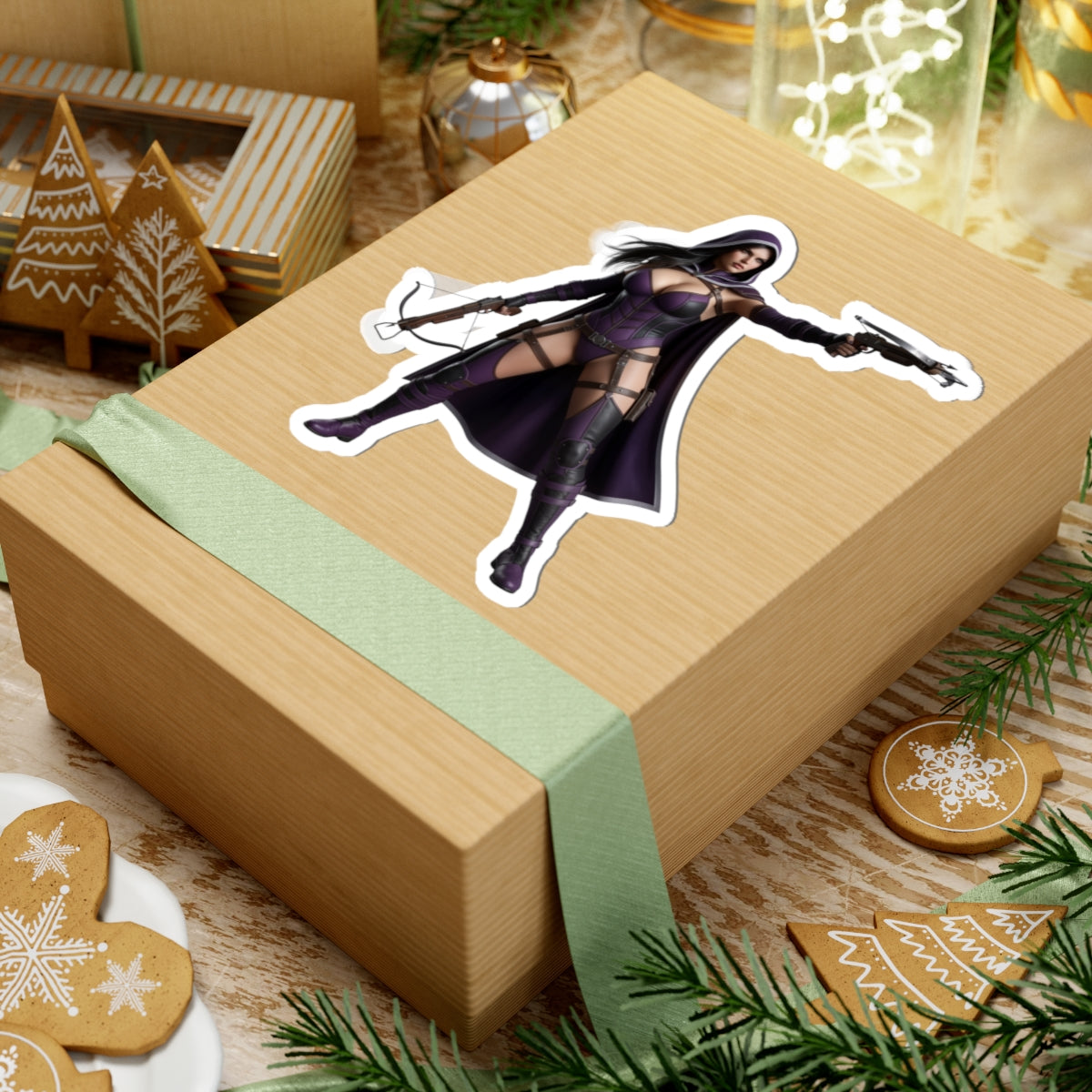 Huntress Sticker – Comic Heroine Vinyl Sticker for Laptops & Indoor Decor on a wrapped gift box, glossy vinyl comic-style vigilante laptop decal