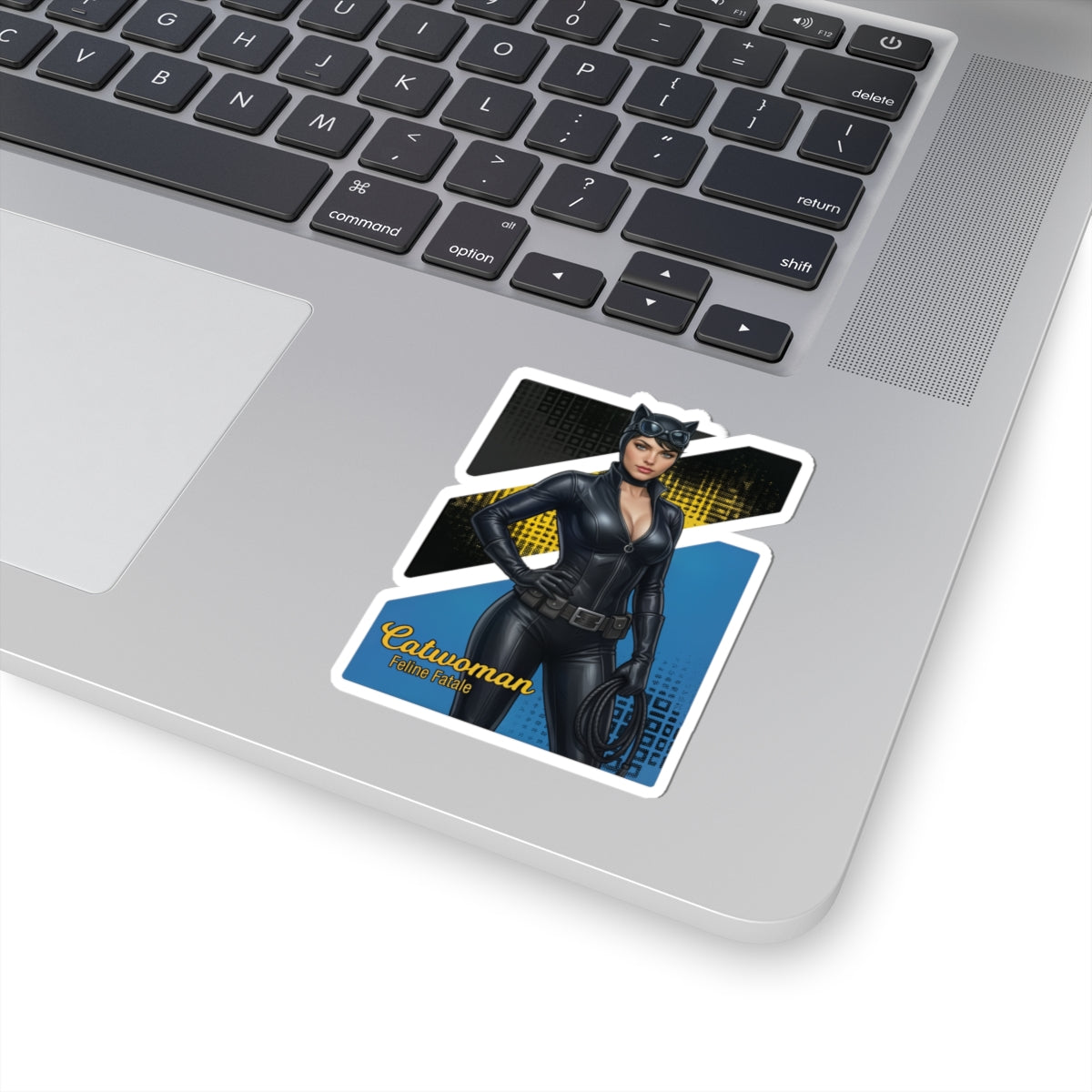 Catwoman Sticker – Comic Heroine Vinyl Sticker for Laptops & Indoor Decor on silver laptop, glossy durable vinyl, vibrant comic-style Catwoman art