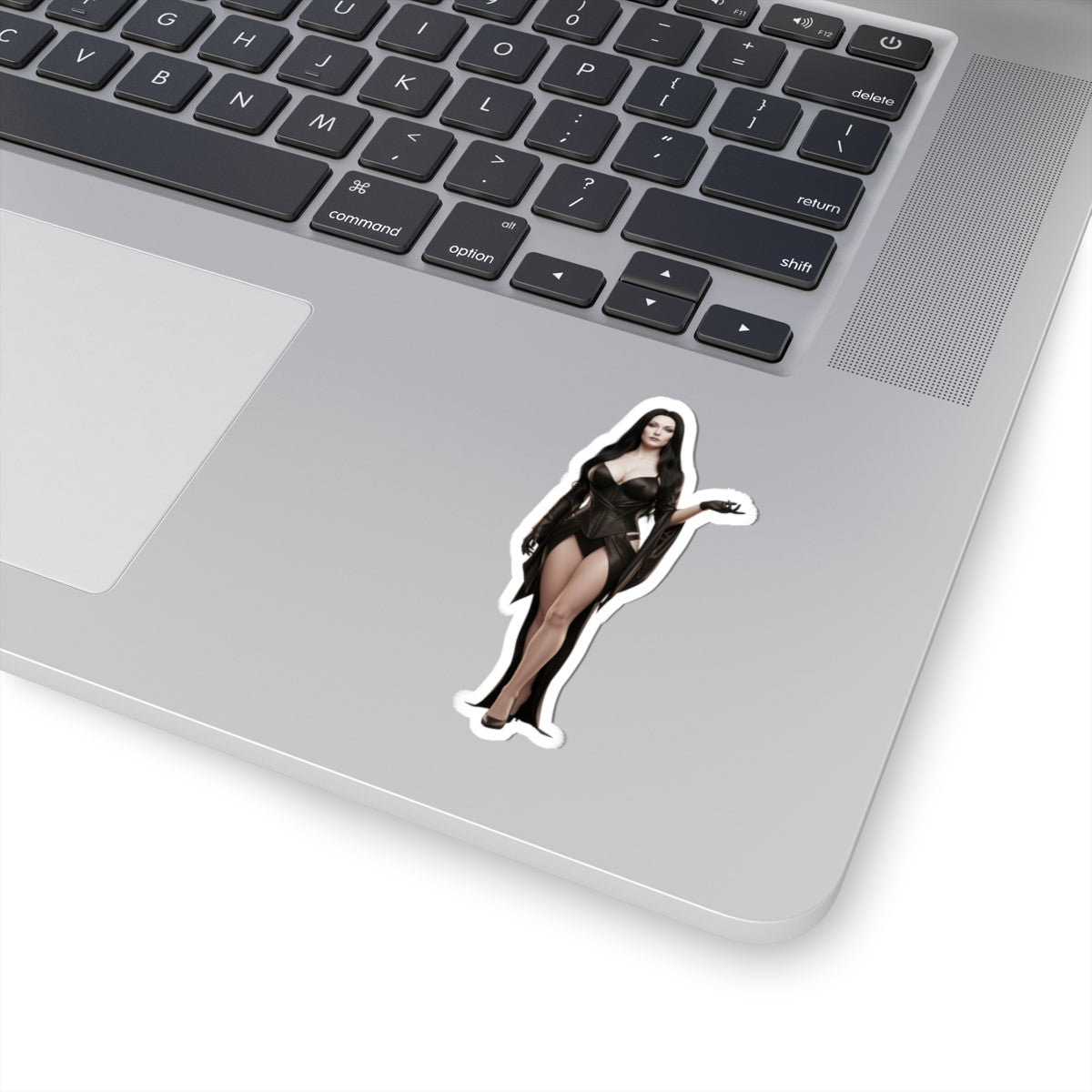 Morticia Addams Sticker – Gothic Character Vinyl Sticker for Laptops & Indoor Decor on silver laptop showing glossy die-cut vinyl sticker of Morticia Addams