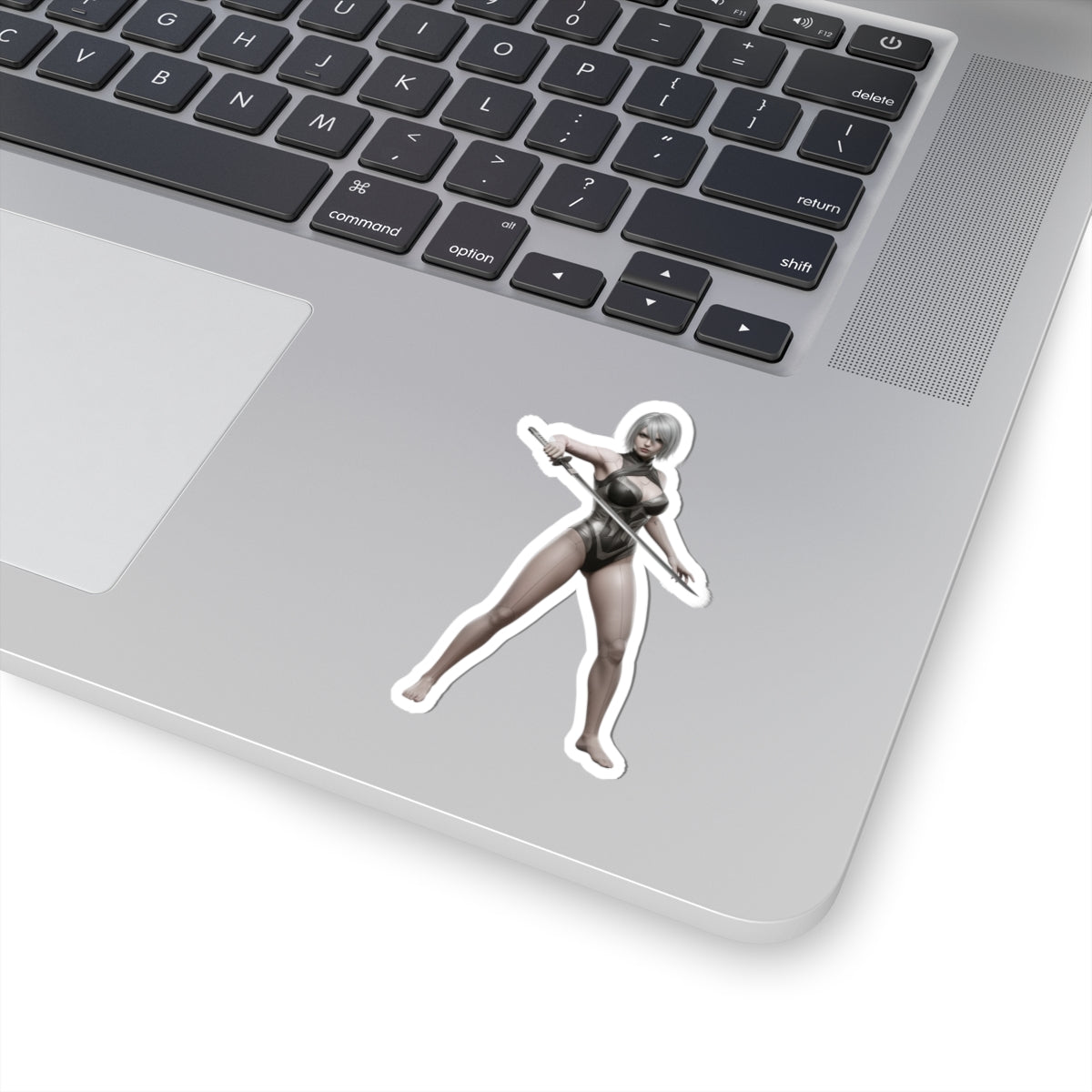 A2 Nier Sticker – Sci-Fi Game Vinyl Sticker for Laptops & Indoor Decor showing glossy die-cut character sticker on a silver laptop corner
