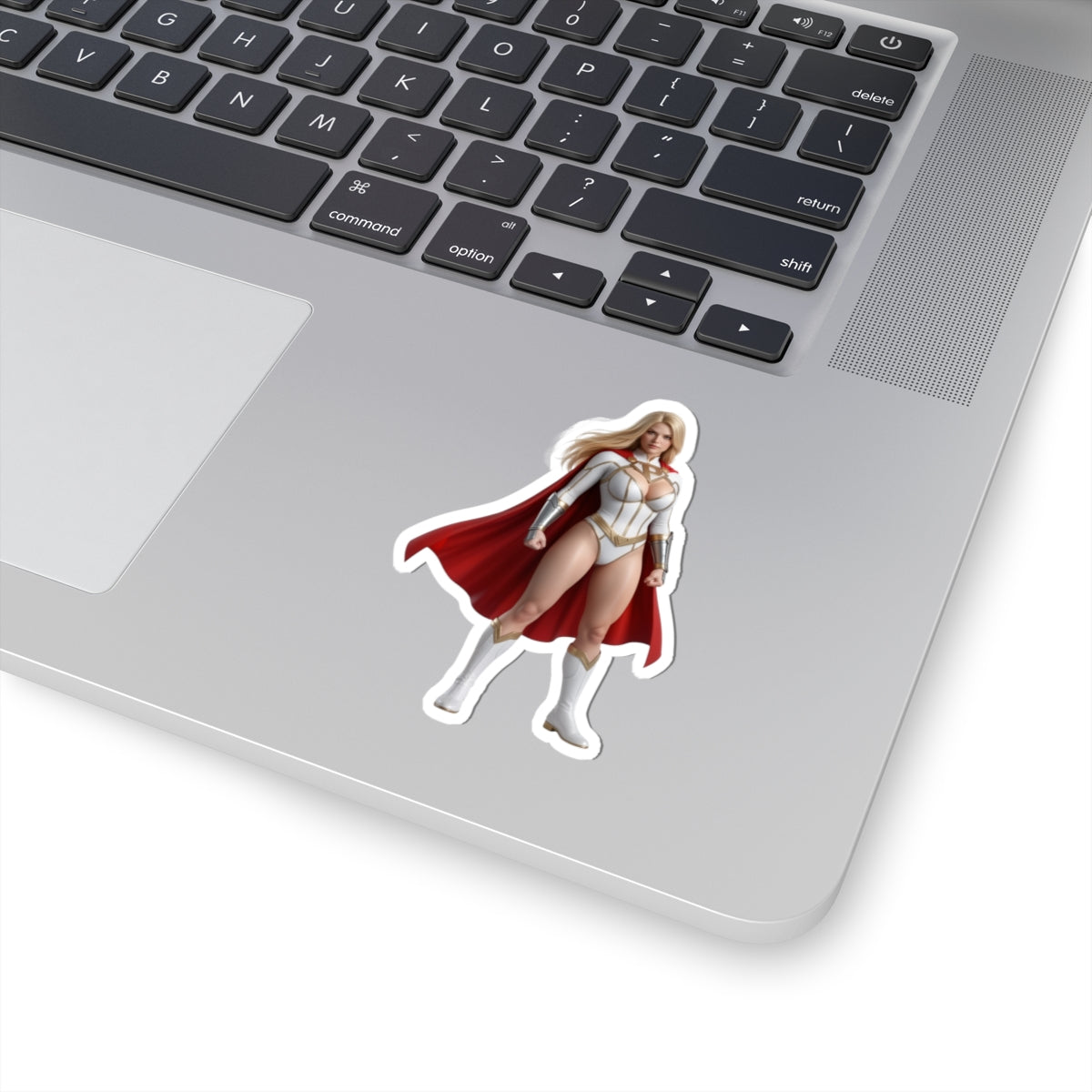 Power Girl Sticker – Comic Heroine Vinyl Sticker for Laptops & Indoor Decor, glossy durable vinyl sticker on silver laptop showing bold comic heroine