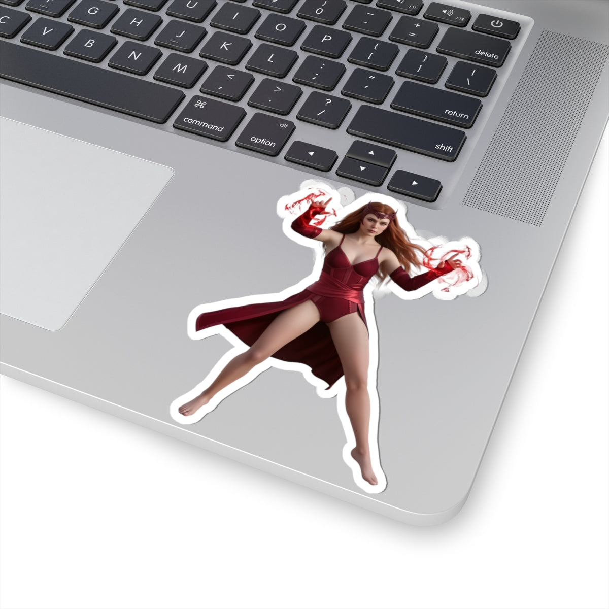 Scarlet Witch Sticker – Comic Heroine Vinyl Sticker for Laptops & Indoor Decor on silver laptop, glossy vibrant red comic-style heroine vinyl sticker